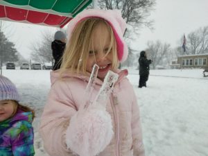 girl playing in the snow
